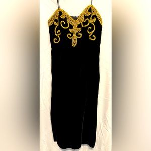 Women’s Strapless/wire black velvet gold trimmed dress by Nancy Bracaloni.